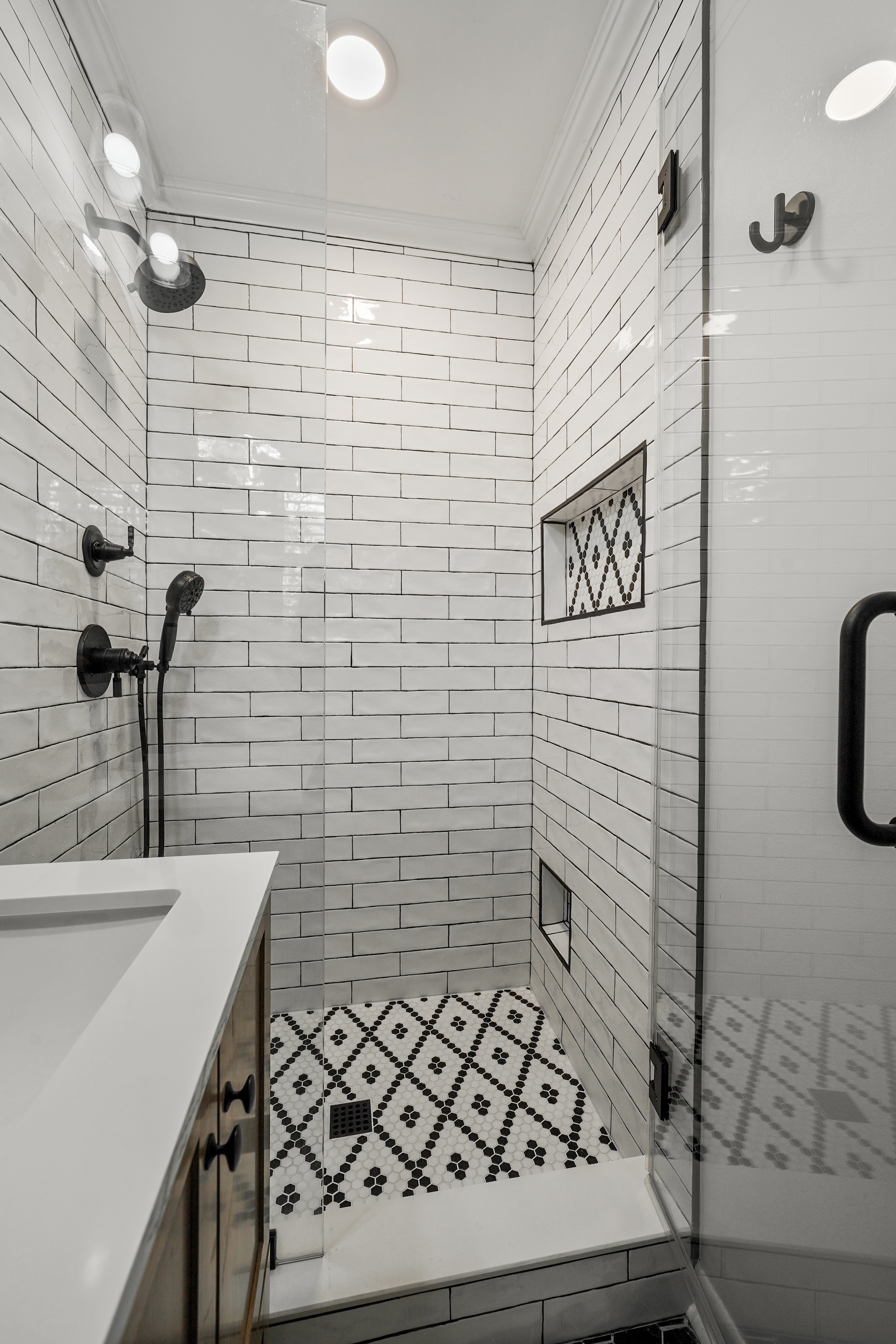 Subway tile shower with pattern floor